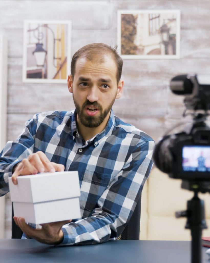 Famous young influencer recording the unboxing of a phone